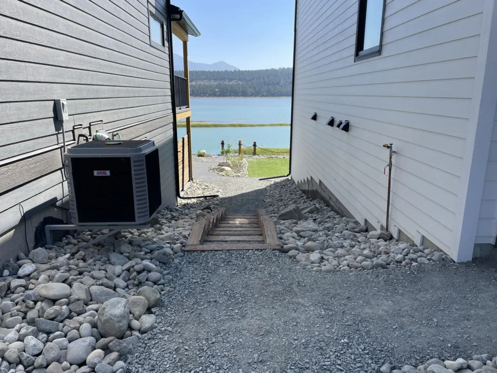 Timber access steps framed by round rock ground cover