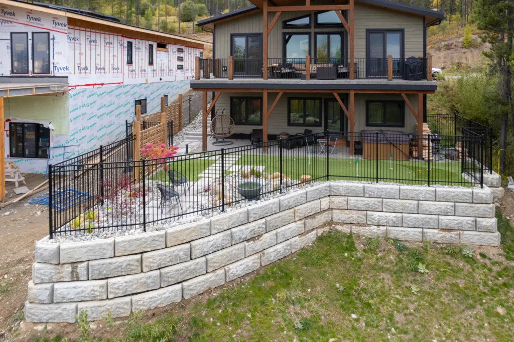 Engineered retaining wall creating a level backyard terrace
