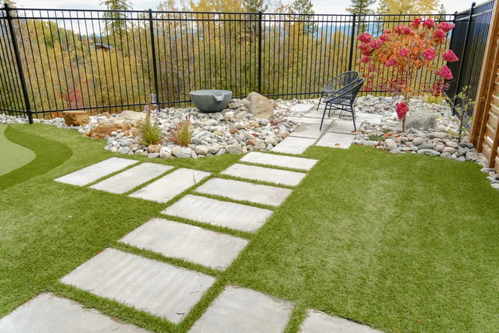 Artforms stepping stones through artificial turf and river rock