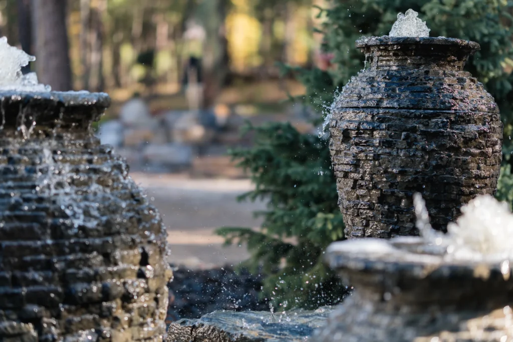 Water cascading over a stacked slate urn