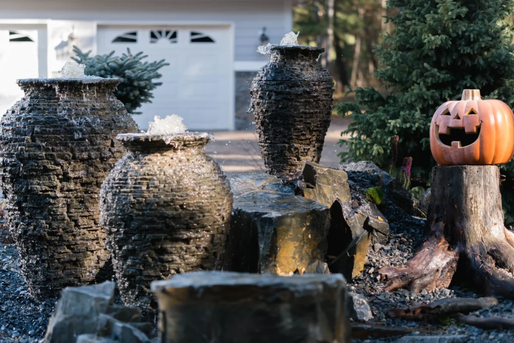 Three Aquascape stacked slate urns at the driveway entrance