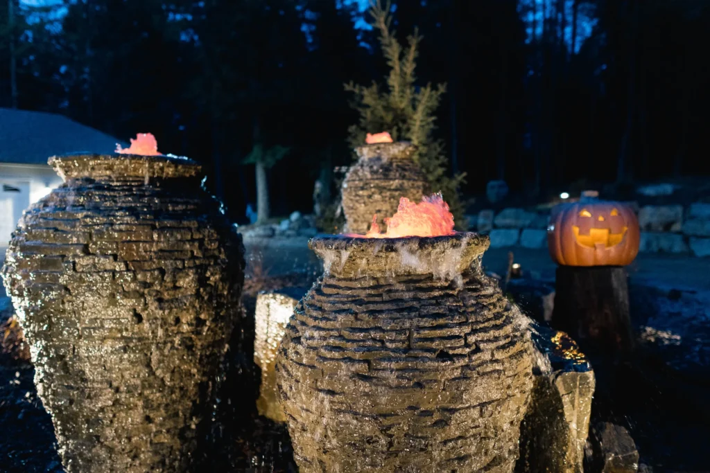 Stacked slate urns glowing within the forested roundabout