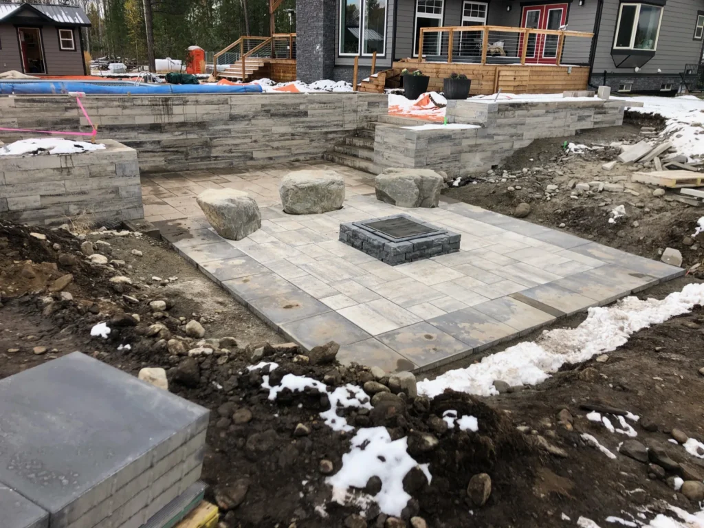 Pool terrace and fire pit taking shape during winter construction