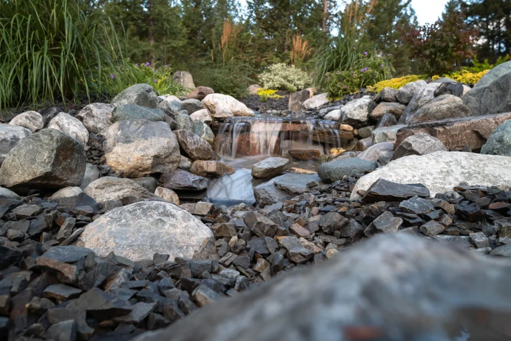 Bubbling brook water feature flowing through round rock