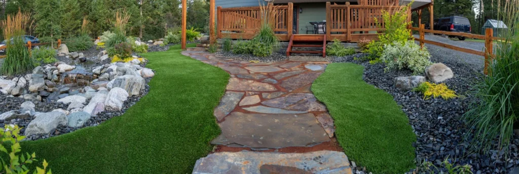 Slate path winding between turf and pollinator planting