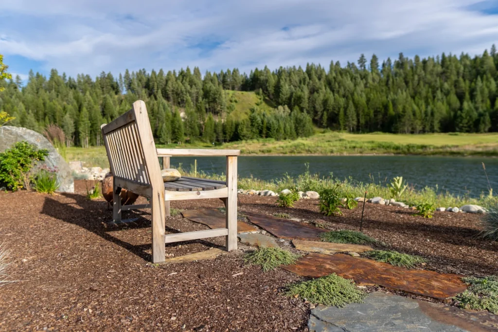 Quiet bench and mulch path beside a mountain lake