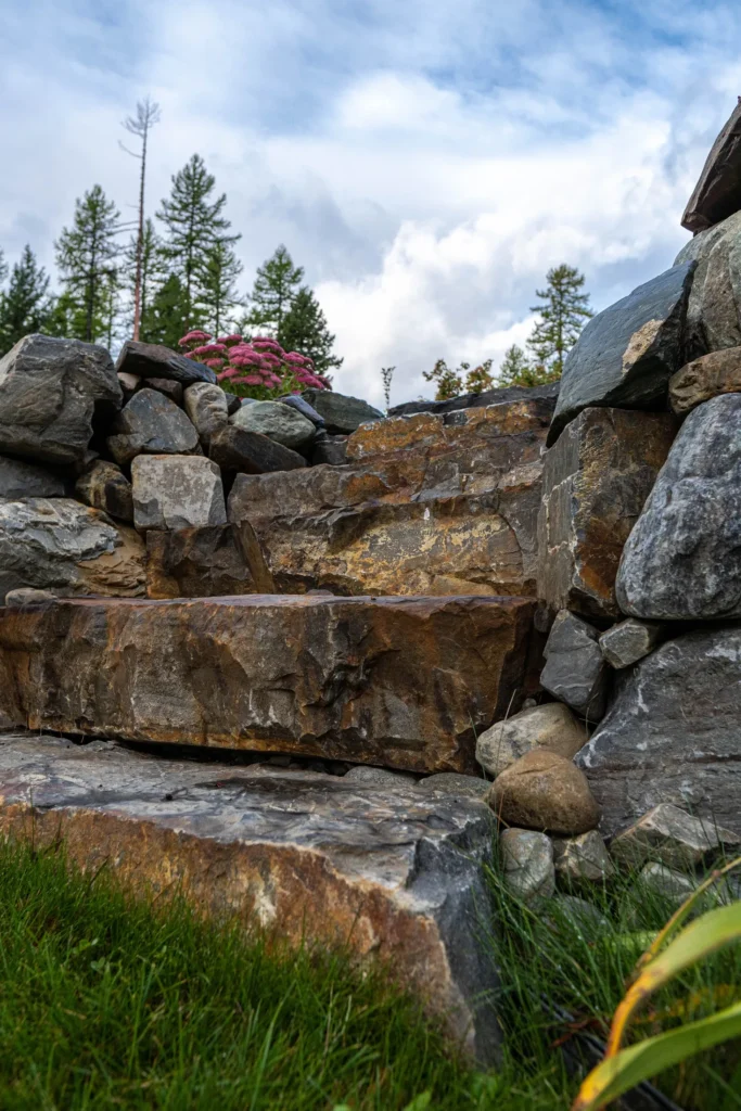 Natural stone entry steps integrated into the rock garden