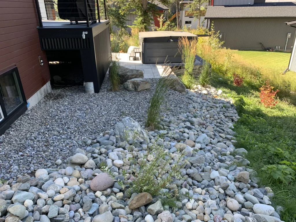 Stone access path descending through the steep side yard
