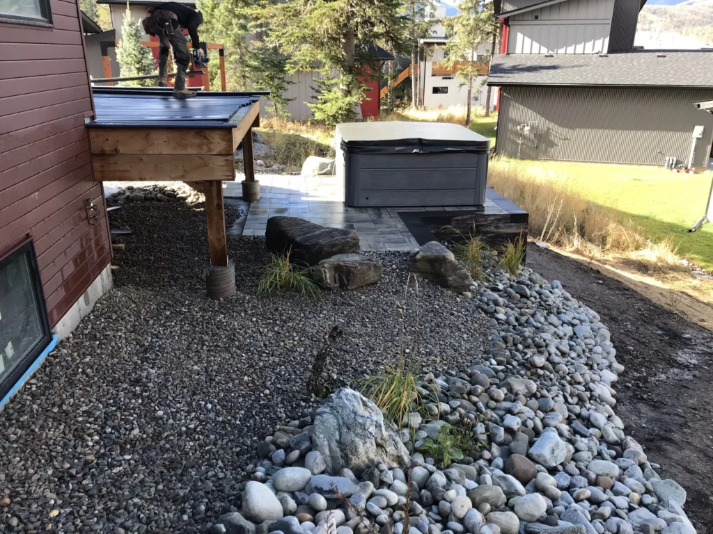 Retaining wall hot tub pad fitted into the hillside
