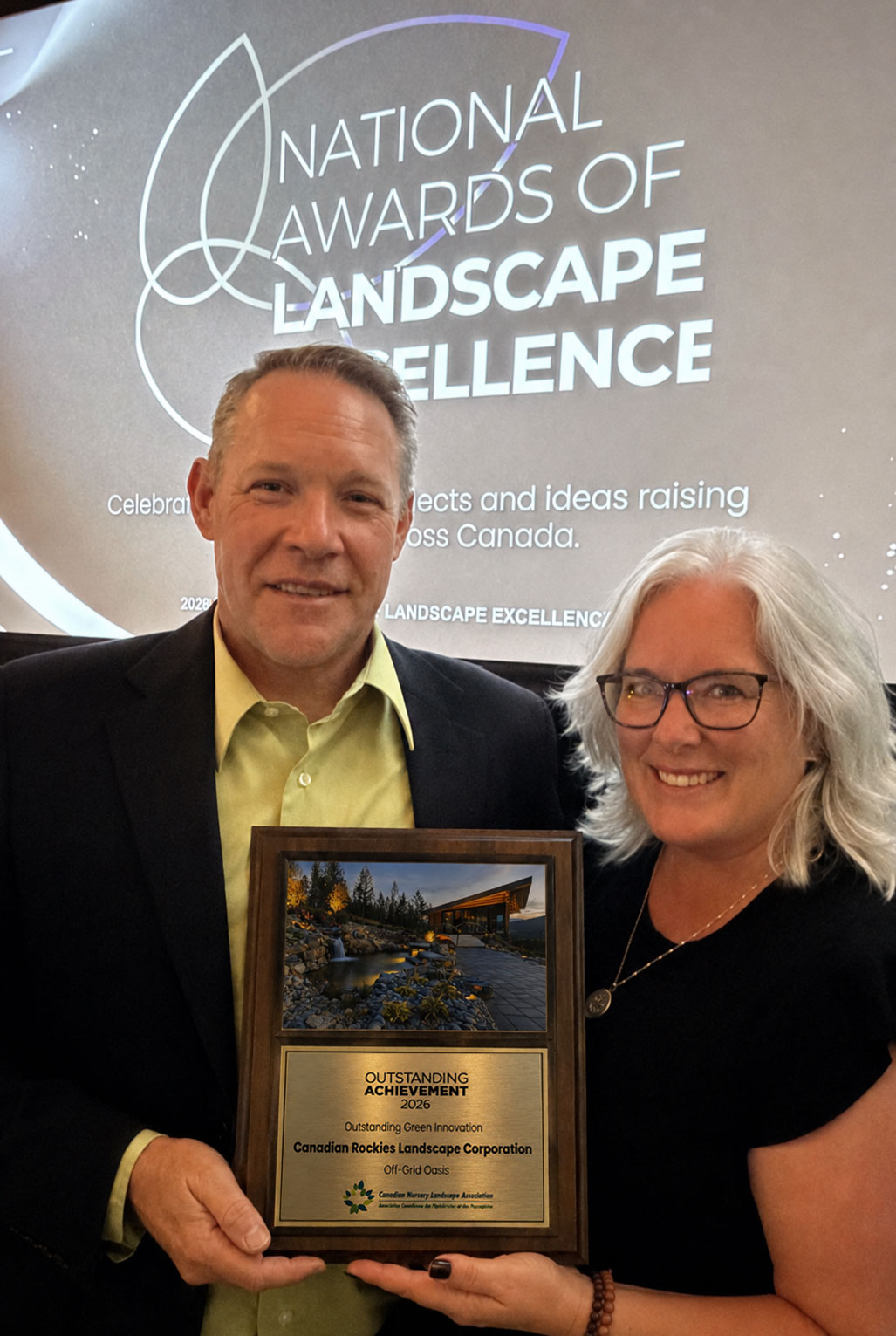 Darren and Jenn Krotz holding the 2026 Outstanding Achievement award for Green Innovation