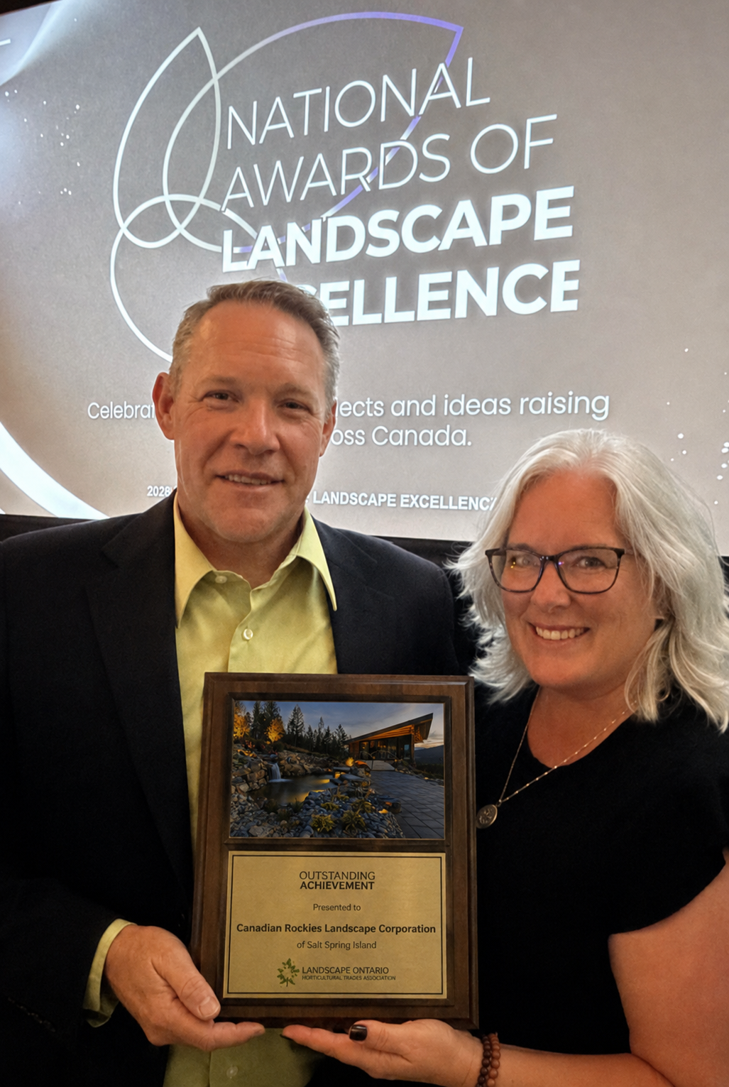 Darren and Jenn Krotz holding the 2026 Outstanding Achievement award for Green Innovation