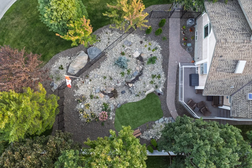 Aerial view of the side yard retreat with rock garden, stream, and turf meditation area