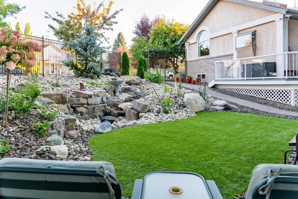 View from the swing seat across the turf lawn to the water feature and home