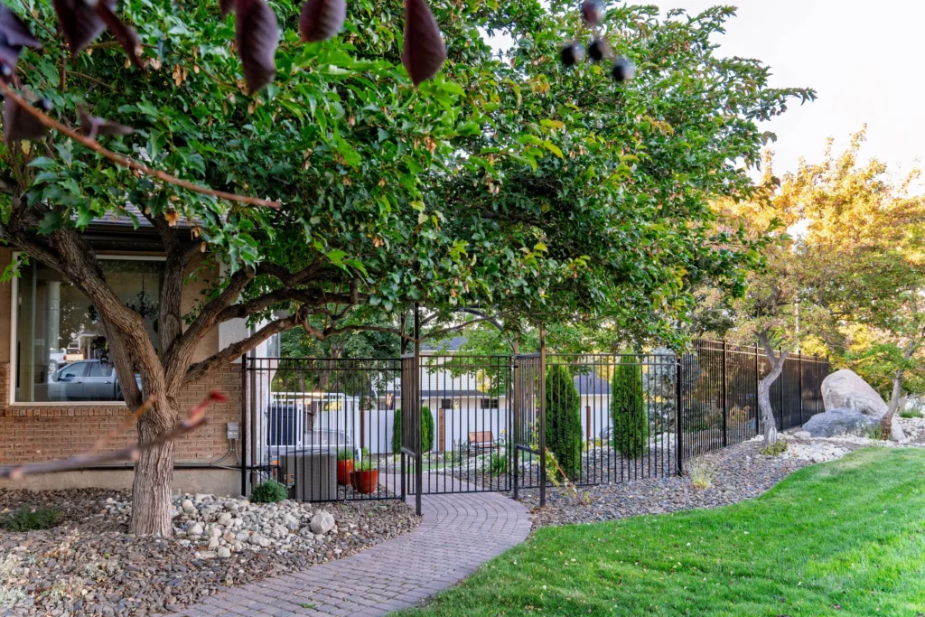 Re-laid paver walkway leading to the ornamental fence and arched arbor gate